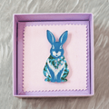 Blue rabbit acrylic brooch with a vintage floral pattern, secure roll pin fastening and presented in a lilac gift box with cleaning cloth.