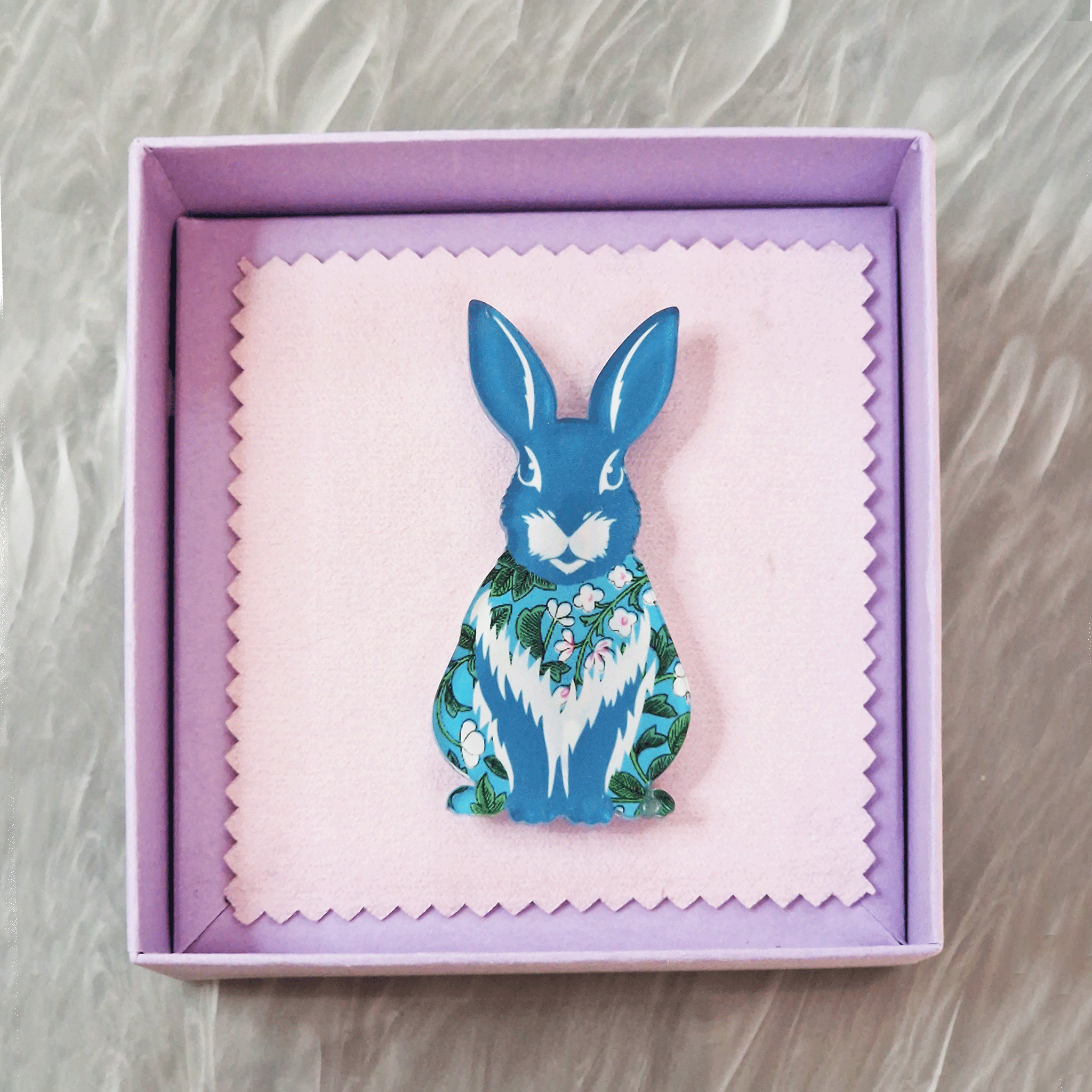 Blue rabbit acrylic brooch with a vintage floral pattern, secure roll pin fastening and presented in a lilac gift box with cleaning cloth.