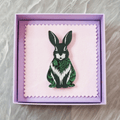 Green rabbit acrylic brooch with a vintage floral pattern, secure roll pin fastening and presented in a lilac gift box with cleaning cloth.