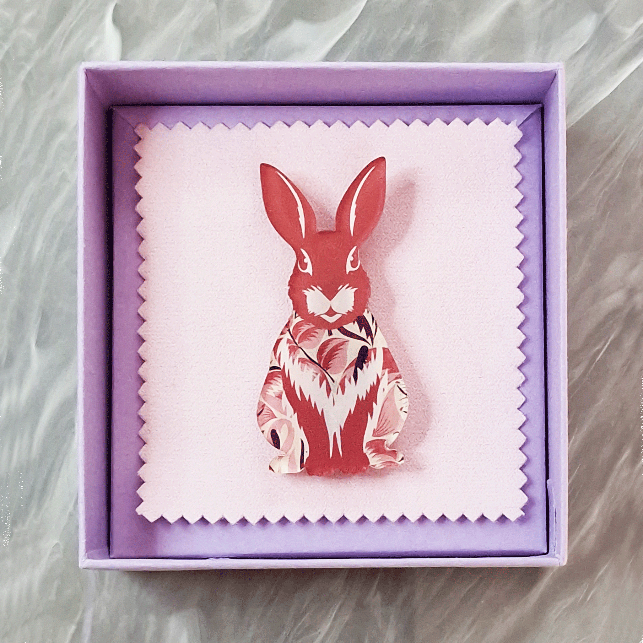 Pink rabbit acrylic brooch with a vintage floral pattern, secure roll pin fastening and presented in a lilac gift box with cleaning cloth.